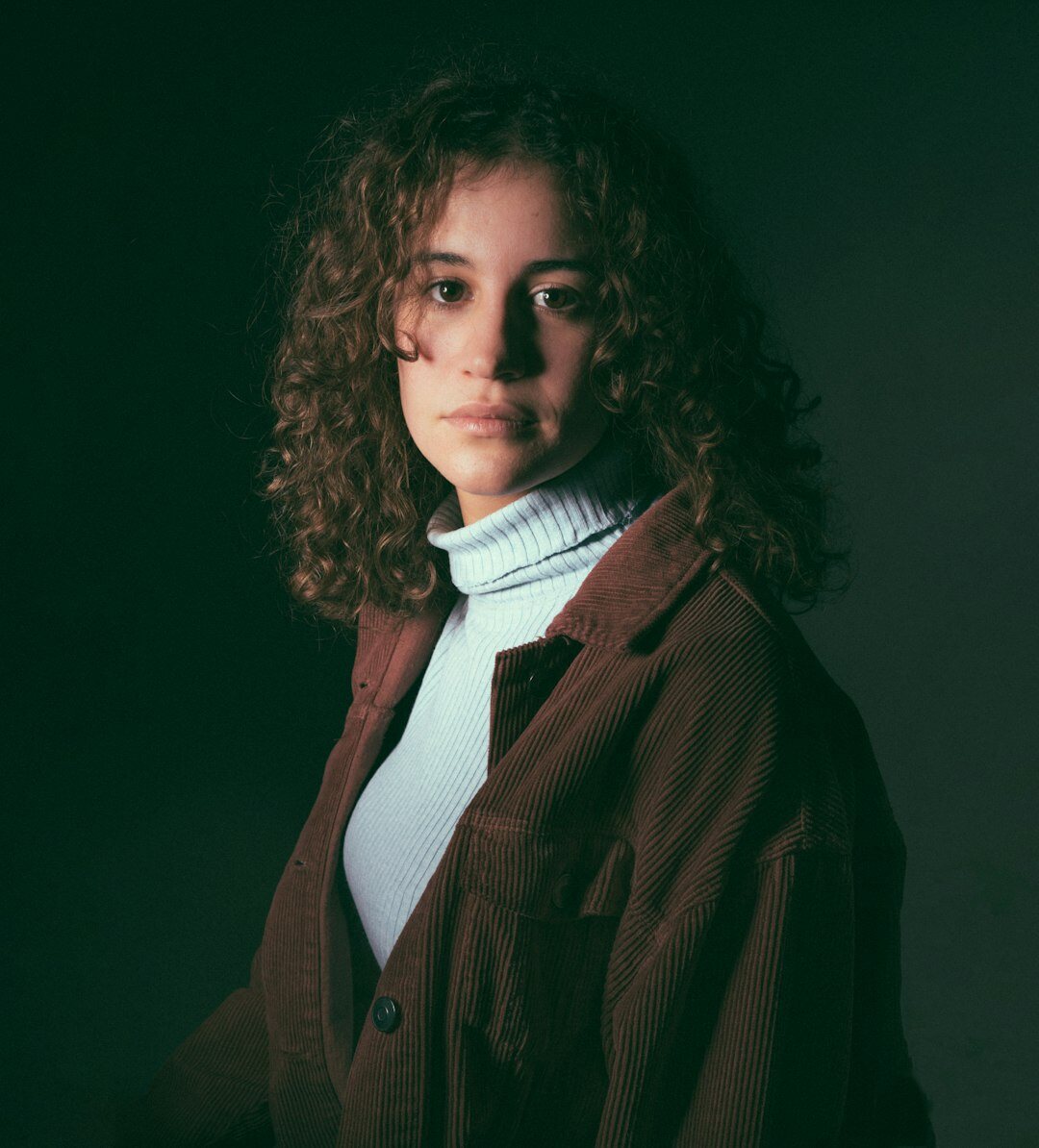 Portrait of a young woman with curly hair smiling