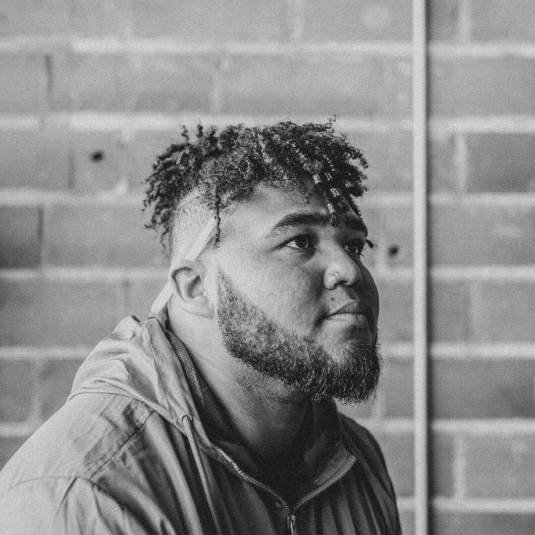 Portrait of a curly haired man with a beard